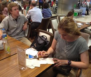 Sean at the Istanbul airport writing postcards while Todd waits