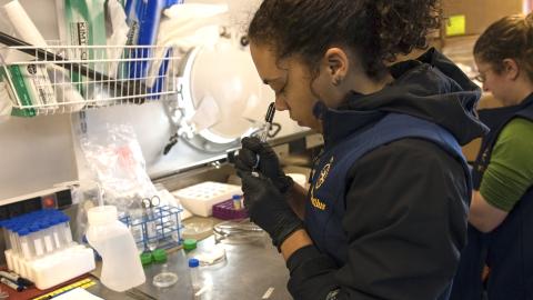 Taylorann Smith marks sample tubes in the wetlab