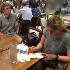 Sean at the Istanbul airport writing postcards while Todd waits