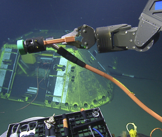 plugging in cable into underwater observatory