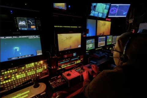 woman operating video station in control van