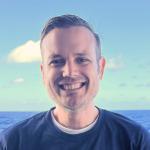 Jeff Beeson smiling with an ocean background