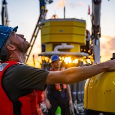Eric Hayden, a mechanical engineer from the Woods Hole Oceanographic Institution, lines up the crane for a Mesobot deployment. Photo by Nova West