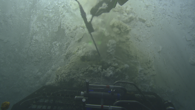 Hercules measures the temperature inside a hydrothermal vent at Toto Caldera. These sulfur rich plumes measured over 100 *C, cooler than the black smoker hydrothermal vents that we hope to see later in the cruise in the back-arc.  