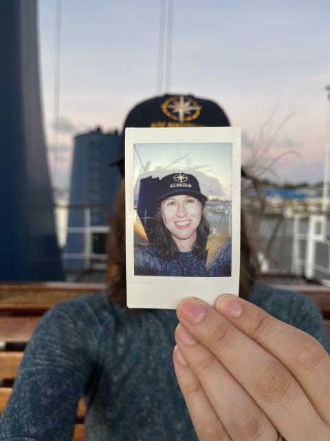 Erin holding a selfie picture of herself in front of her face