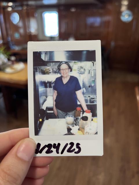 A woman poses in a kitchen