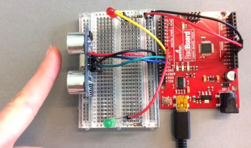 Finger beside a Arduino breadboard circuit
