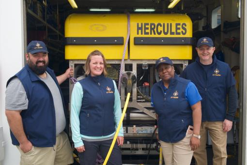 Group shot of Nautilus Ambassadors with ROV Hercules