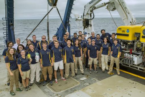 Group picture of 30 explorers on the back deck of the ship