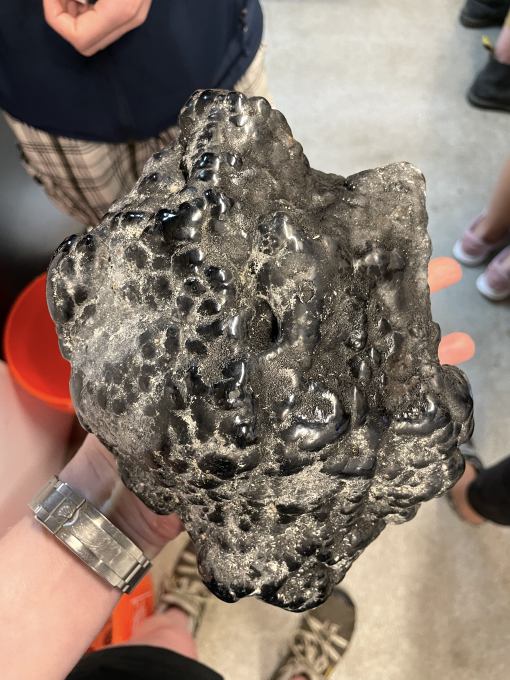 Dark black rock coated in ferromanganese crust