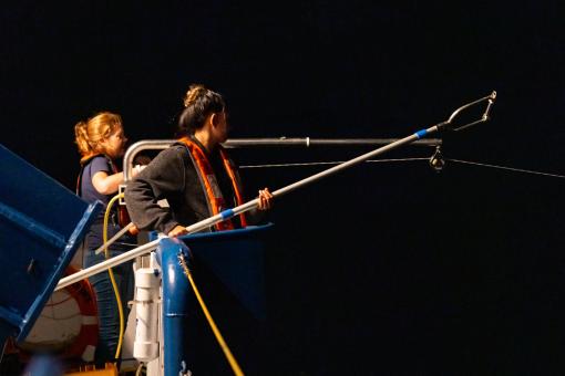 Anne and Darrian recover an Underway Conductivity Temperature and Depth (UCTD) sensor cast during their night time watch.