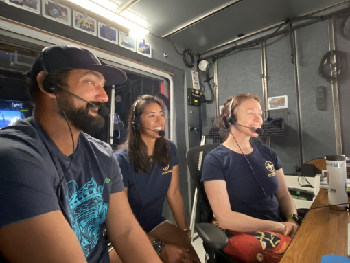 Team members Daniel Kinzer, Ariana Agustinas, and Jennie Berglund sit together in the broadcast studio