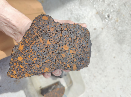 Cross section of a pōhaku (basalt rock) sample collected during the Ala ʻAumoana Kai Uli expedition which will be analyzed to understand the story of its formation. 