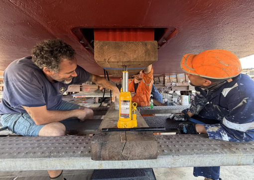 Franco Pilone (Kongsberg) and Corps of Exploration members installing the new transducers in E/V Nautilus's hull.